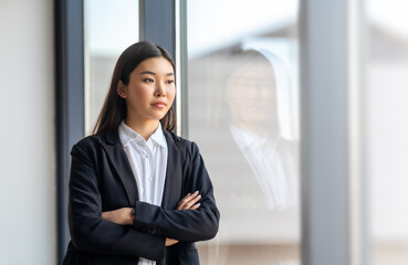 asian woman looking outside window