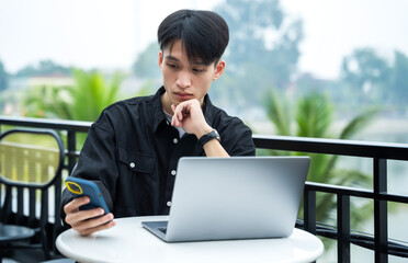 image of young asian male working at a cafe