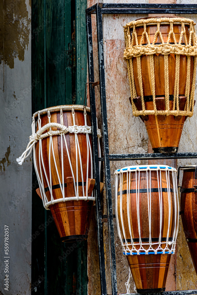 Wall mural atabaques (drums) displayed for sale in a musical instrument shop in salvador in bahia