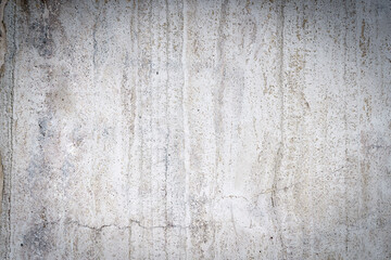 Old concrete stone wall covered with cracked plaster and dirty grunge textured surface.