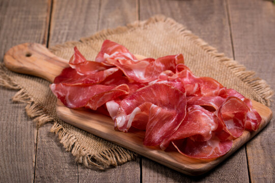 Italian slices of coppa, capocollo, capicollo, bresaola or cured ham with rosemary. Raw food.  