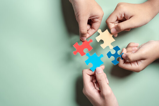 Color puzzle symbol of awareness for autism spectrum disorder family support. Father, Mother, Children holding jigsaw puzzle Autism World Awareness Day.