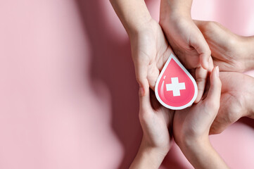 hands holding blood drop paper cut, blood transfusion, world blood donor day, red cross to give...