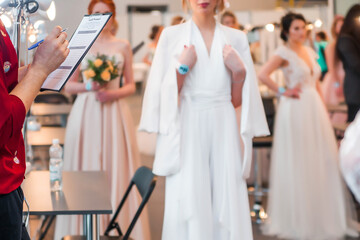 Competition of wedding stylists. The jury of the competition evaluates the hairstyles of the models.