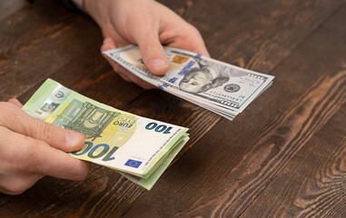 Choice - dollars or euros, Exchange dollars to euro money in male hand.