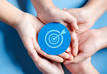 Business hands holding target icon, dartboard and arrow for creative and set up business objective...