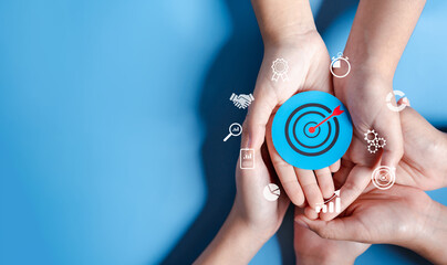 Business hands holding target icon, dartboard and arrow for creative and set up business objective target goal, marketing solution, target for business investment.