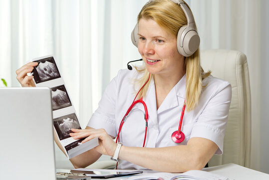 Female doctor showing her patient picture of ultrasound image of her baby on the laptop. teletreatment. gynecology gynecologist education medicine healthcare feminine health pregnancy preparation