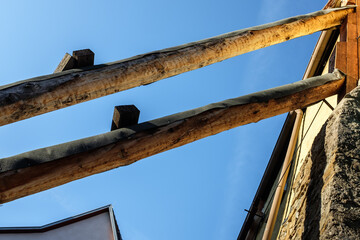 Fototapeta na wymiar Stützbalken an Hausruine gegen blauen Himmel