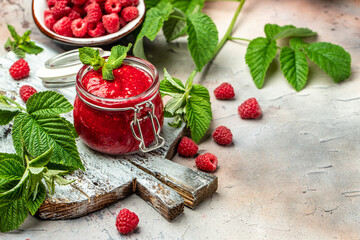 Raspberry jam with berry on light background. Homemade jam with raspberry. banner, menu, recipe place for text, top view