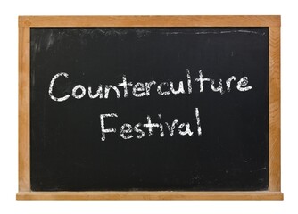 Counterculture festival written in white chalk on a black chalkboard isolated on white