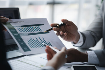 The sales department is having a monthly summary meeting to bring it to the department manager, they are verifying the correctness of the documents that are prepared before bringing in to the manager