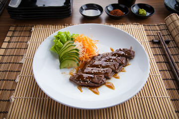 Teriyaki Japanese-style food, where the food is heated or grilled and coated with soy sauce, sake, mirin, flavored sugar which is then called Teriyaki sauce.