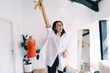 Happy woman in sewing workshop