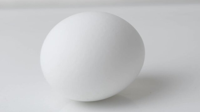 The white egg slowly sways from side to side