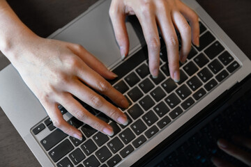 Fototapeta na wymiar closeup hand typing keyboard on labtop of businesswoman during technology online connection business work for education and study business concept