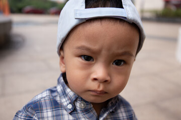 Asian kid portrait outdoor looking into the camera 