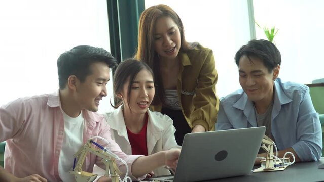 group of asian young university students brainstorming and discussion with laptop computer  in college library  science and technology subject