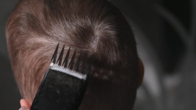 Haircuts Of Blond Hair For A Boy With A Clipper, Close-up.Hair Care Concept.Mother Cuts Son's Hair At Home With A Clipper.