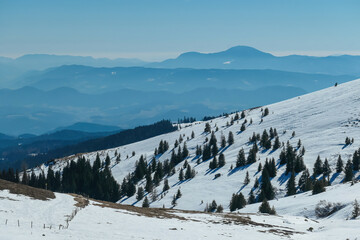 Scenic view of snow covered alpine meadows and Karawanks mountains seen from Ladinger Spitz, Saualpe, Lavanttal Alps, Carinthia, Austria. Untouched field of snow. Ski touring snowshoeing tourism