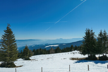 Scenic view of snow covered alpine meadows and Karawanks mountains seen from Ladinger Spitz,...