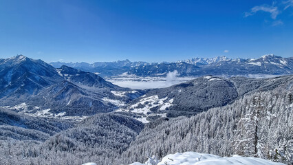Fototapeta premium Scenic view of snow capped mountain peak Dobratsch, Julian Alps and the Karawanks (Karawanken) seen from Kobesnock in Bad Bleiberg, Carinthia, Austria, Europe. Winter wonderland landscape on sunny day