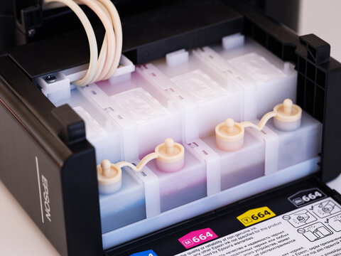Tambov, Russian Federation - December 06, 2022 A Close-up shot of a continuous ink system of Epson printer