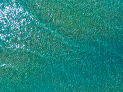 Sea surface aerial view,Bird eye view photo of blue waves and water surface texture,Turquoise sea background, Beautiful nature Amazing view sea background