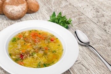 Tasty fresh soup dish in plate with bread
