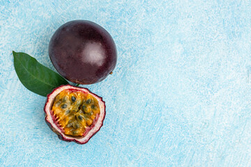 Purple passion fruit with cut in half on a blue background, Long banner format. top view