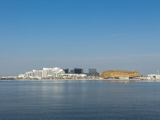 Fototapeta na wymiar A view of Yas Bay Waterfront and Etihad Arena on Yas Island, Abu Dhabi