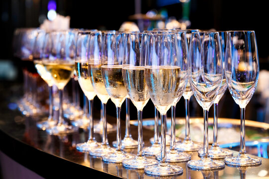 Champagne Flute Glass and wine glass on the bar counter ready to serve and drink in the party. Celebration and party concept.