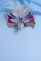 Festive face mask for carnival or masquerade celebration on colored background. Carnival background...