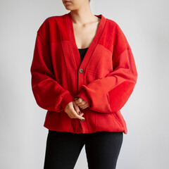 Woman wearing red oversized cardigan and black jeans isolated on white background