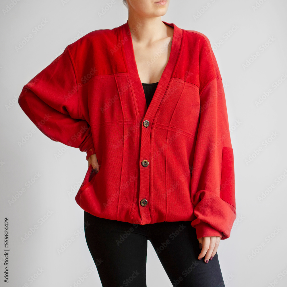Wall mural Woman wearing red oversized cardigan and black jeans isolated on white background - Wall murals