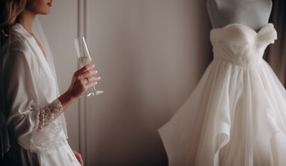 bride holding glass of champagne in hand