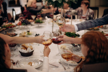 people, celebration, party, holidays and drink concept-close up of woman hands holding champagne at restaurant