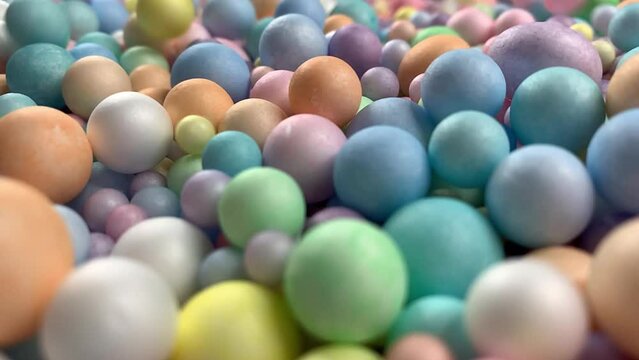 Many colorful rainbow foam balls balloons. Pile of multicolor spheres rolling, falling and flying.