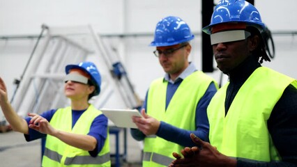 Multiracial engineers working with augmented reality glasses at robotic factory - Metaverse Virtual innovation