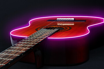 Acoustic  guitar with glowing neon border  on a black background