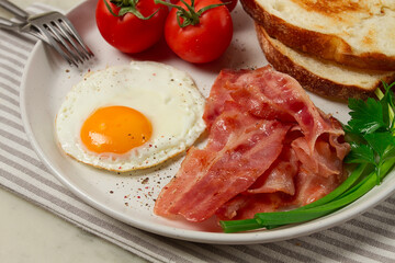 Breakfast, fried egg, bacon and bread, with cherry, on a light background, homemade, no people,