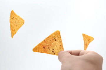 hand holding nachos chips isolated on white background. chosing doritos