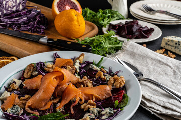 Smoked salmon tops a winter salad loaded with seasonal 