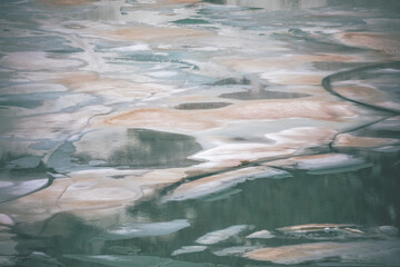 Fototapeta premium view of the iced alpine lake melting