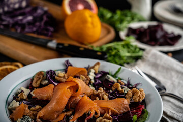 Smoked salmon tops a winter salad loaded with seasonal 