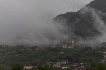View of Santo Stefano del Sole on the hill with low clouds, Irpinia, Avellino, Campania, Italia.