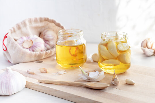 Fermented garlic cloves in a jar of honey. Healthy food and medicine from nature, honey for strong immunity, Fermented honey with garlic, a rich source of probiotics