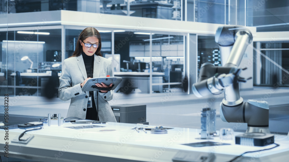 Poster young beautiful female engineer using a tablet computer, researching and developing a futuristic rob