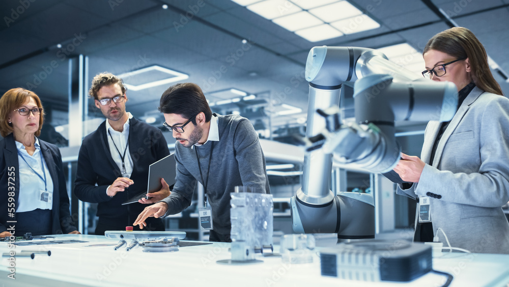 Poster Creative Team of Multicultural Engineers Use Tablet Computer, Analyze and Discuss How a Futuristic Robotic Arm Works and Moves a Metal Object. High Tech Research Laboratory with Modern Equipment.