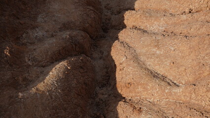 View of soil erosion. Rain water streams made bizarre shapes of clay earth.